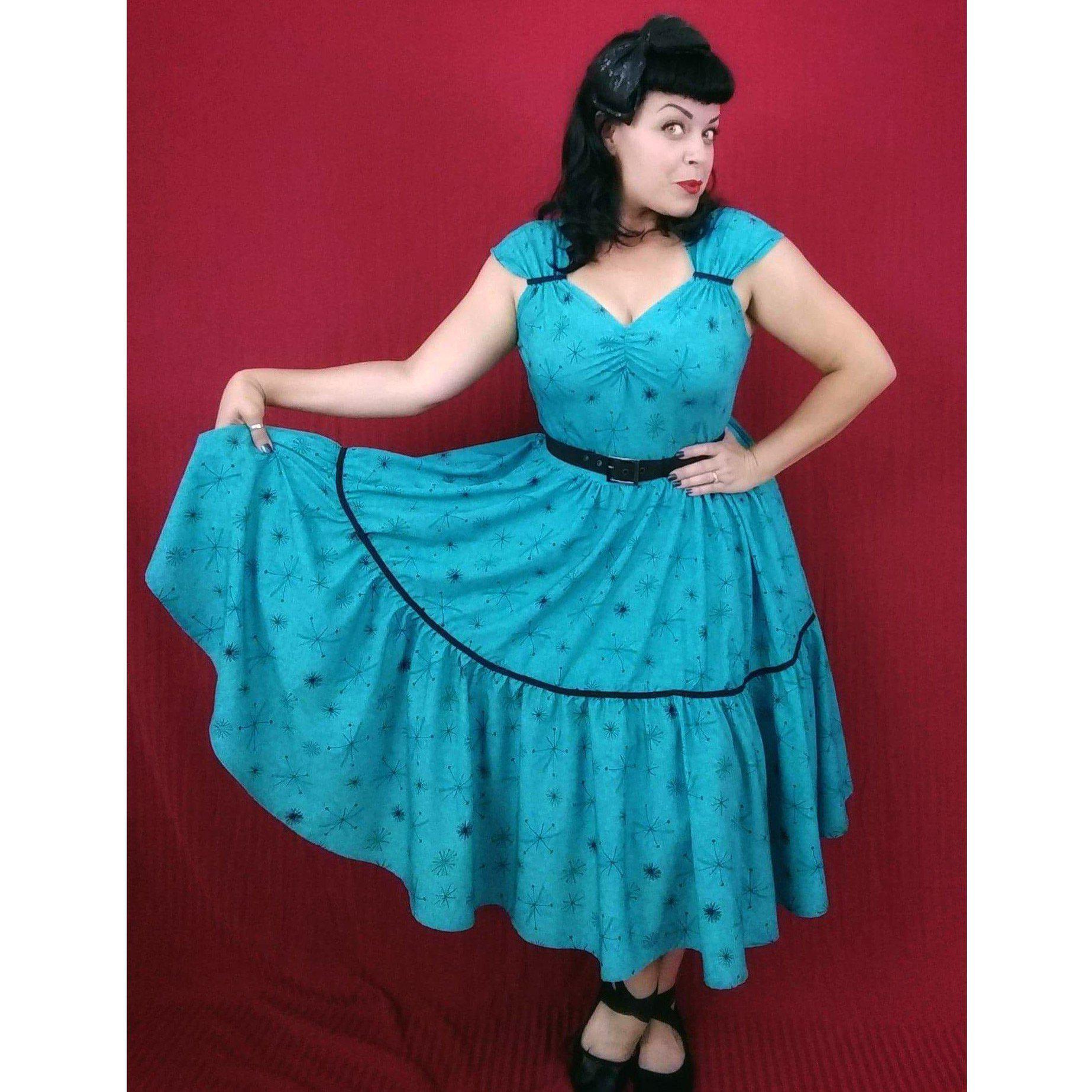 Olivia Swing Dress in Turquoise Atomic Print Glitz Glam and Rebellion Olivia Swing Dress in Turquoise Atomic Print Glitz Glam and Rebellion